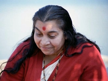 Shri Mataji with red cardigan looking down