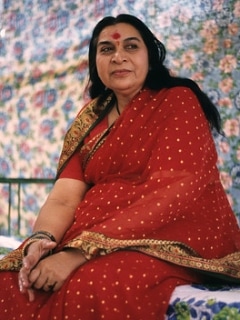 Shri Mataji sitting with red sari