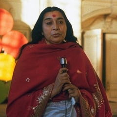 Shri Mataji speaks holding microphone