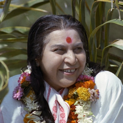 Shri Mataji Nirmala Devi with Indian garland